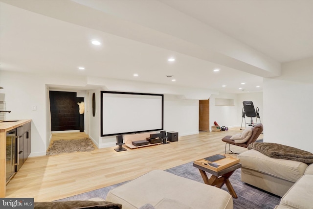 cinema room featuring recessed lighting, a sink, and light wood-style flooring