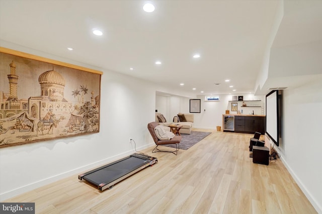workout room featuring indoor bar, recessed lighting, baseboards, and wood finished floors