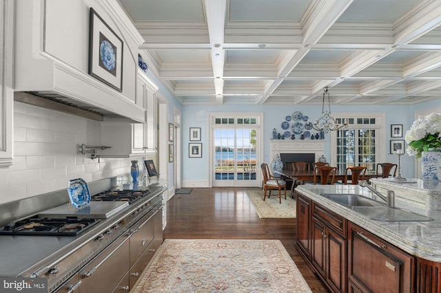 8620 Bozman Neavitt, Saint Michaels, MD 21663 - kitchen featuring a fireplace, beamed ceiling, coffered ceiling, and dark wood finished floors