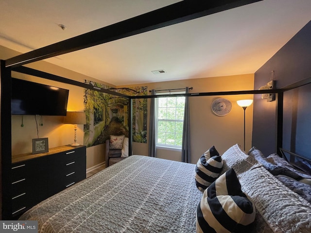 bedroom featuring baseboards and visible vents