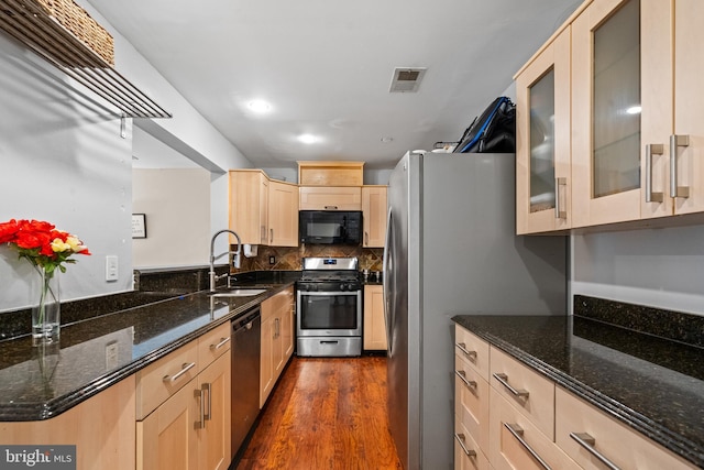 4029 Chetham Way Unit 20, Woodbridge, VA 22192 - kitchen featuring light brown cabinets, glass insert cabinets, a sink, dark stone countertops, and stainless steel appliances