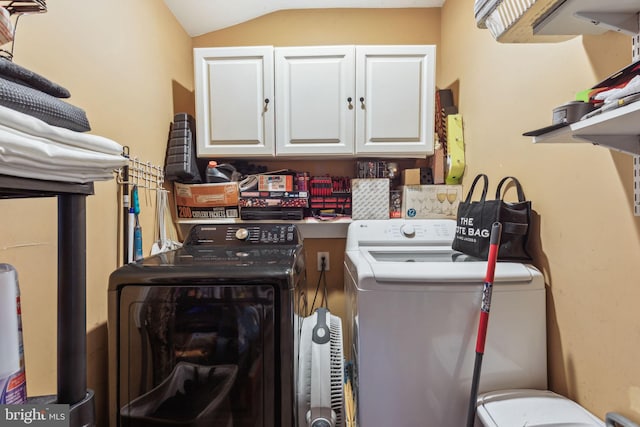 laundry room featuring separate washer and dryer and cabinet space