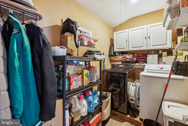 laundry room with wood finished floors, cabinet space, and washer and clothes dryer