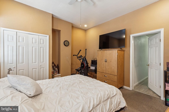 carpeted bedroom with ceiling fan, baseboards, and a closet