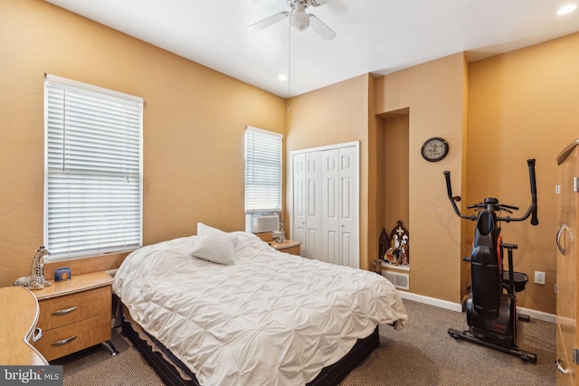bedroom with a ceiling fan, baseboards, cooling unit, a closet, and dark carpet