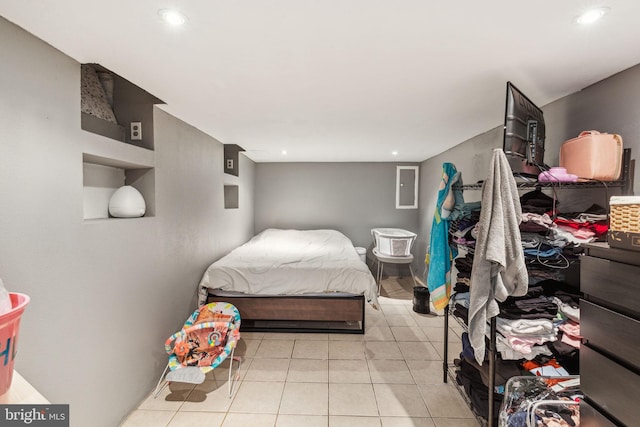 bedroom featuring light tile patterned floors, electric panel, and recessed lighting
