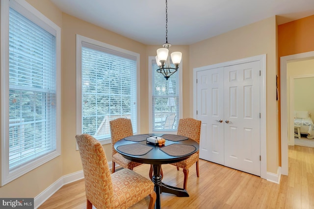 22758 Red Bay Ln, Milton, DE 19968 - dining area featuring light wood-type flooring, a chandelier, and baseboards