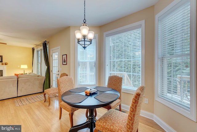 22758 Red Bay Ln, Milton, DE 19968 - dining space with light wood-style floors, a chandelier, and baseboards