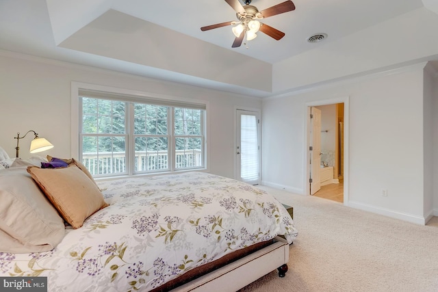 22758 Red Bay Ln, Milton, DE 19968 - carpeted bedroom featuring a tray ceiling, multiple windows, baseboards, and ensuite bath
