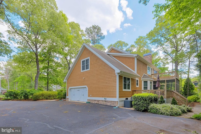 22758 Red Bay Ln, Milton, DE 19968 - view of home's exterior with a chimney, stairs, central AC unit, a deck, and a garage