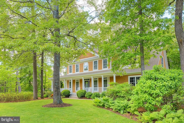 22758 Red Bay Ln, Milton, DE 19968 - colonial house featuring covered porch and a front yard