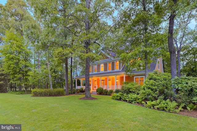 22758 Red Bay Ln, Milton, DE 19968 - view of front of house featuring a front lawn and covered porch