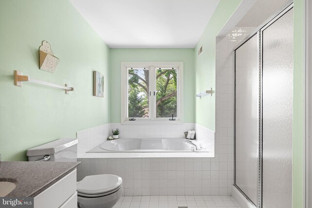 bathroom with vanity, tile patterned floors, a bath, and a stall shower
