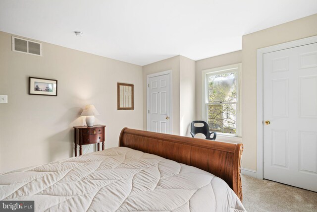 bedroom featuring visible vents, carpet, and baseboards