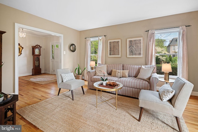 living area featuring baseboards and wood finished floors