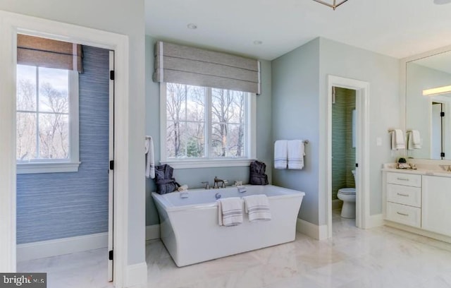 916 Prescott, Berwyn, PA 19312 - bathroom featuring baseboards, a freestanding bath, toilet, vanity, and marble finish floors