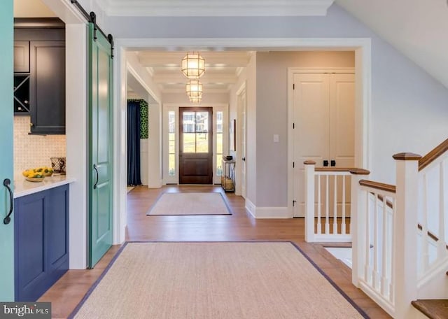 916 Prescott, Berwyn, PA 19312 - foyer entrance featuring a barn door, light wood-type flooring, and ornamental molding