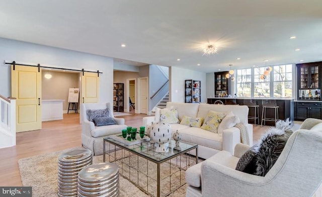 916 Prescott, Berwyn, PA 19312 - living area featuring a barn door, stairway, light wood-type flooring, recessed lighting, and bar area
