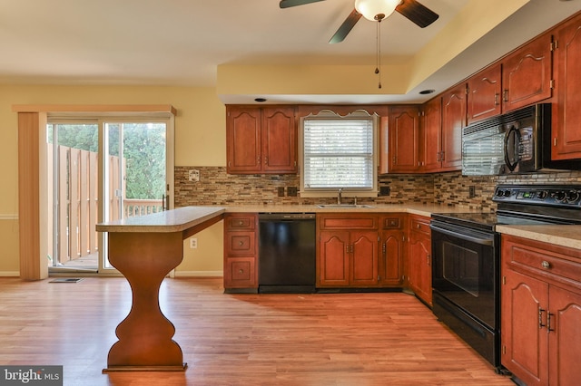 1514 Ravena St Unit D, Bethlehem, PA 18015 - kitchen featuring backsplash, a sink, light countertops, black appliances, and light wood finished floors
