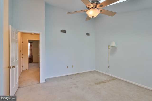 1514 Ravena St Unit D, Bethlehem, PA 18015 - spare room featuring a ceiling fan, visible vents, baseboards, a high ceiling, and light carpet