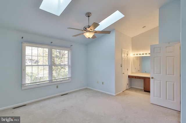 1514 Ravena St Unit D, Bethlehem, PA 18015 - unfurnished bedroom with connected bathroom, light carpet, vaulted ceiling with skylight, baseboards, and visible vents