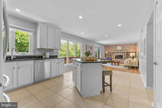 kitchen featuring a sink, a wealth of natural light, open floor plan, and dishwasher