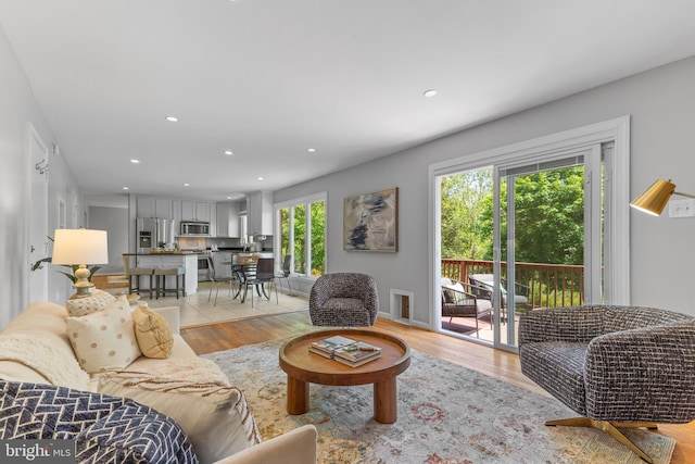 living room with recessed lighting and light wood-style flooring