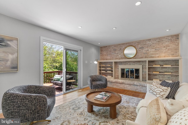 living room with recessed lighting, baseboards, and wood finished floors
