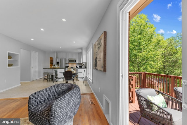 interior space with recessed lighting, baseboards, visible vents, and light wood finished floors