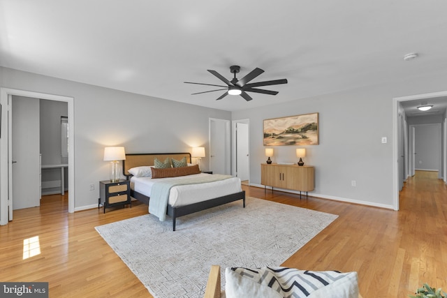 bedroom featuring baseboards, light wood-style flooring, and ceiling fan