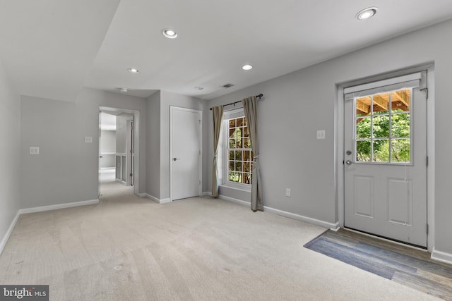 foyer featuring recessed lighting, baseboards, visible vents, and light carpet