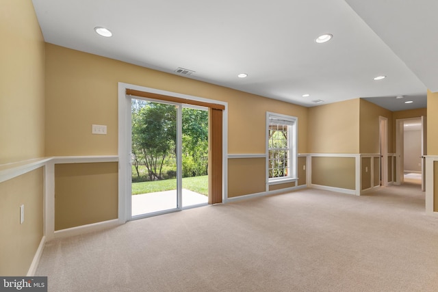 empty room with baseboards, carpet flooring, recessed lighting, and visible vents