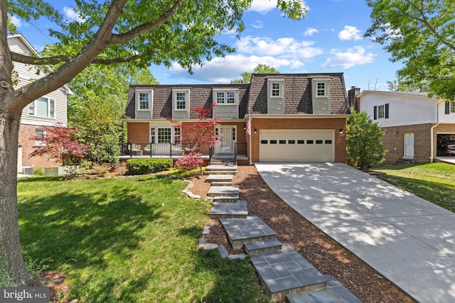 view of front of property featuring concrete driveway, brick siding, mansard roof, and a shingled roof