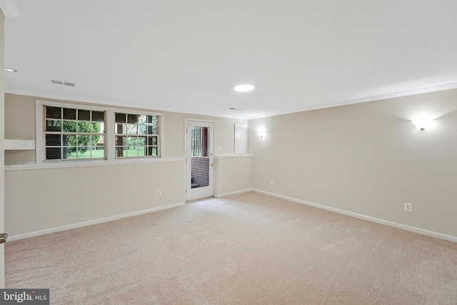 unfurnished room with light colored carpet, crown molding, baseboards, and recessed lighting