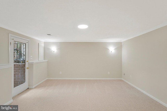 empty room with crown molding, baseboards, and light colored carpet