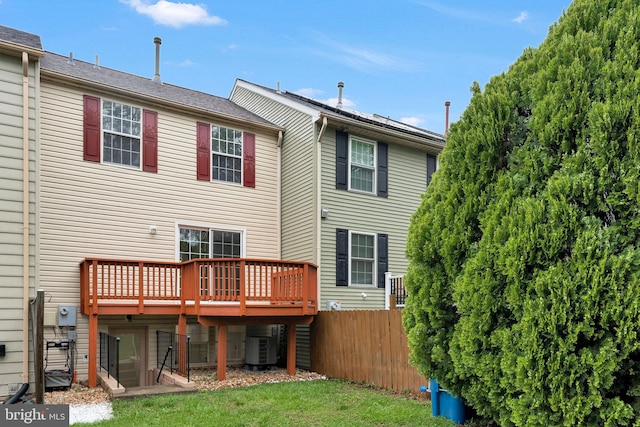 rear view of house featuring a deck and cooling unit