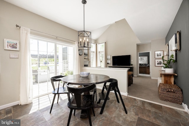 dining space featuring a chandelier, baseboards, and visible vents