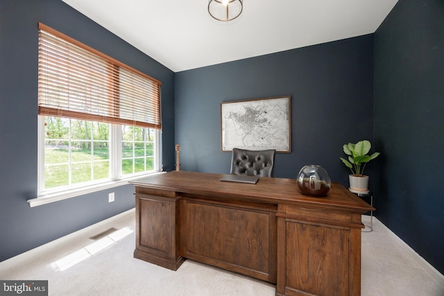 office area featuring baseboards, visible vents, and light carpet