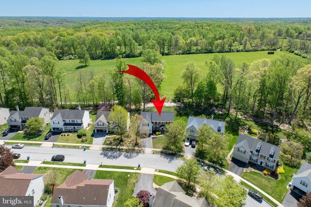 bird's eye view with a residential view and a wooded view