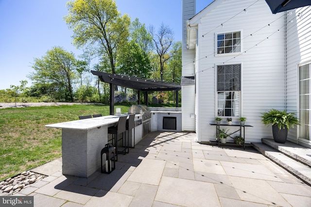 view of patio / terrace with outdoor wet bar, a pergola, and area for grilling