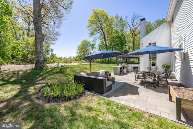view of patio featuring an outdoor living space, outdoor dining area, exterior kitchen, and grilling area