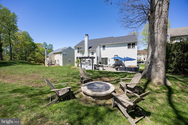 view of yard featuring a fire pit and a patio area