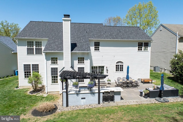 back of property featuring a chimney, central air condition unit, a patio, a yard, and a pergola