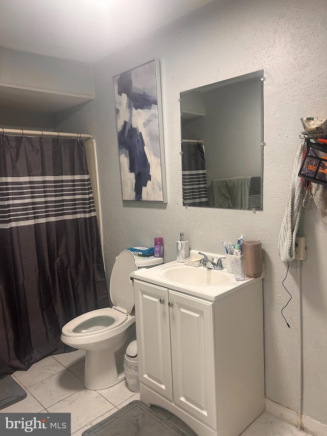 bathroom with toilet, a shower with shower curtain, marble finish floor, and vanity