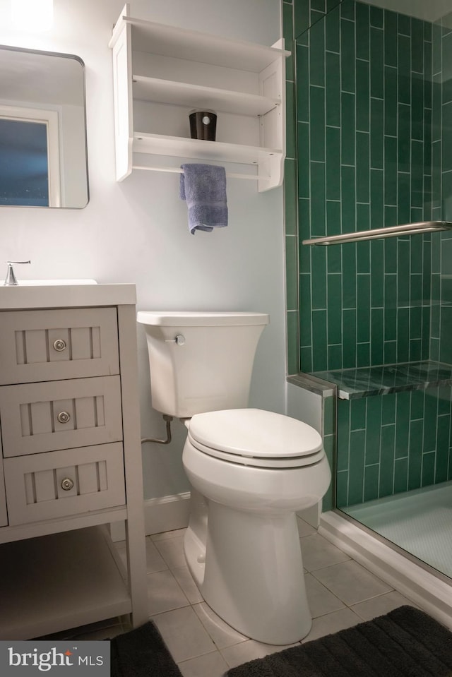 bathroom with vanity, tile patterned floors, toilet, and a shower stall