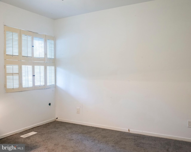 empty room featuring baseboards, carpet, and visible vents