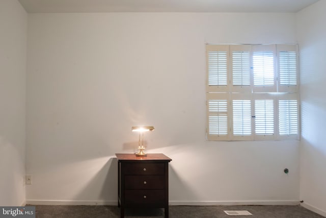 unfurnished bedroom featuring carpet flooring, visible vents, and multiple windows
