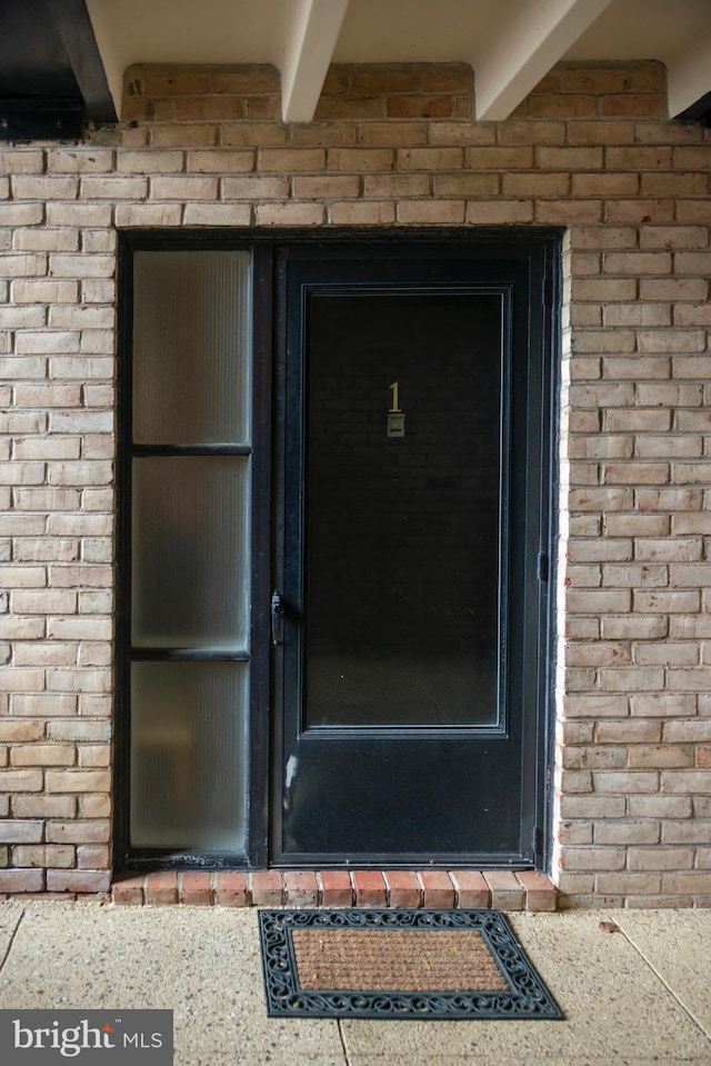 property entrance with brick siding