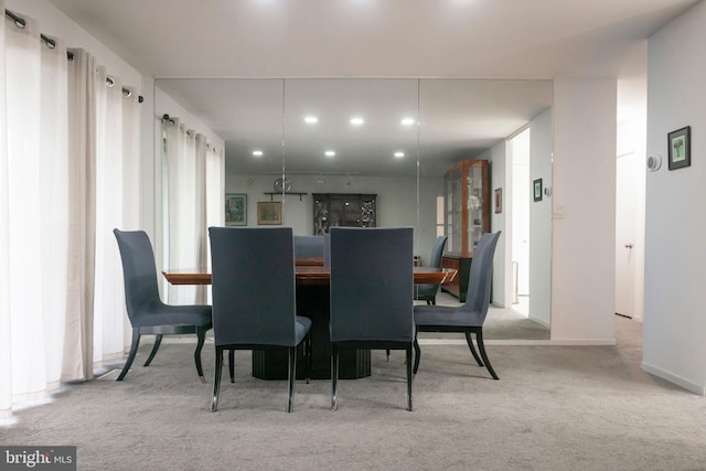 carpeted dining room with recessed lighting and baseboards