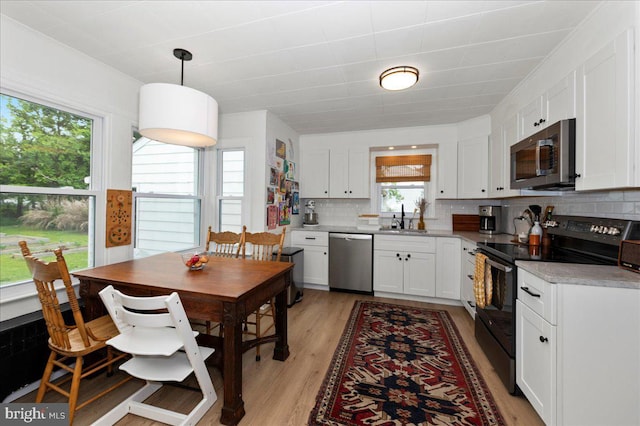 1708 Wrightfield Rd, Yardley, PA 19067 - kitchen featuring stainless steel appliances, white cabinets, backsplash, and light wood-type flooring